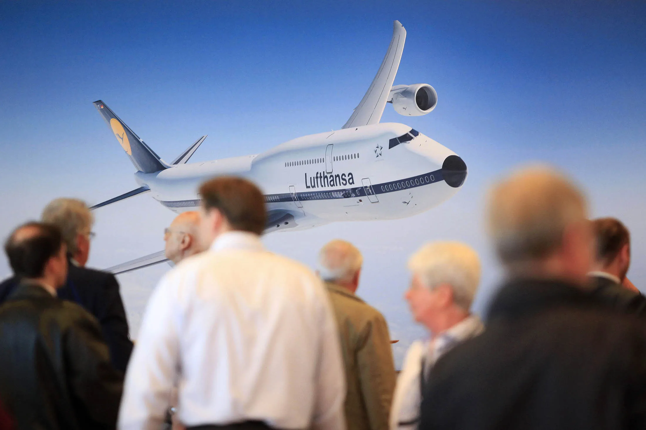 An image of a Lufthansa airplane sits on a display banner in Hamburg.
