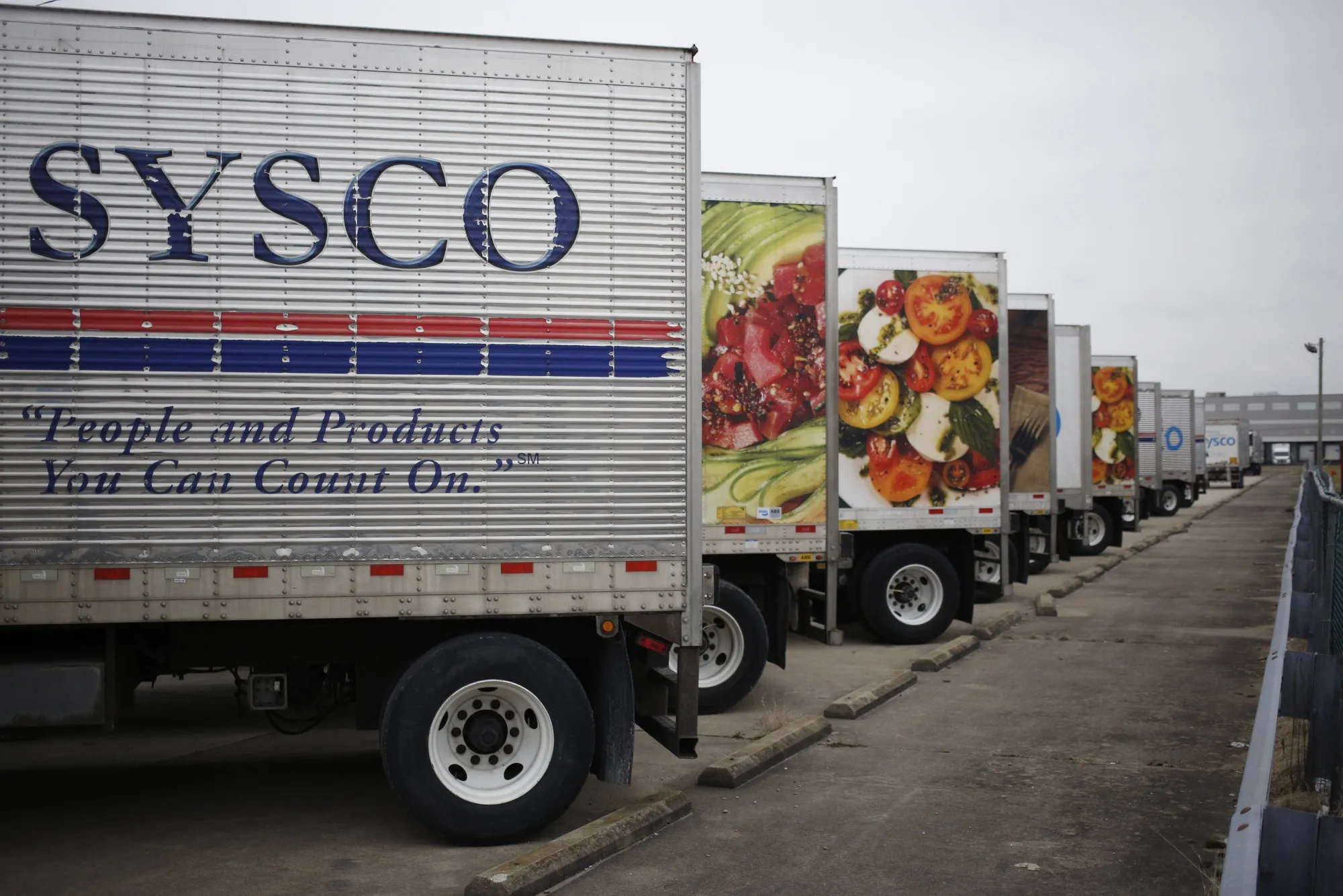 Sysco Corp. delivery trucks sit parked outside the company's distribution center in Louisville, Kentucky.
