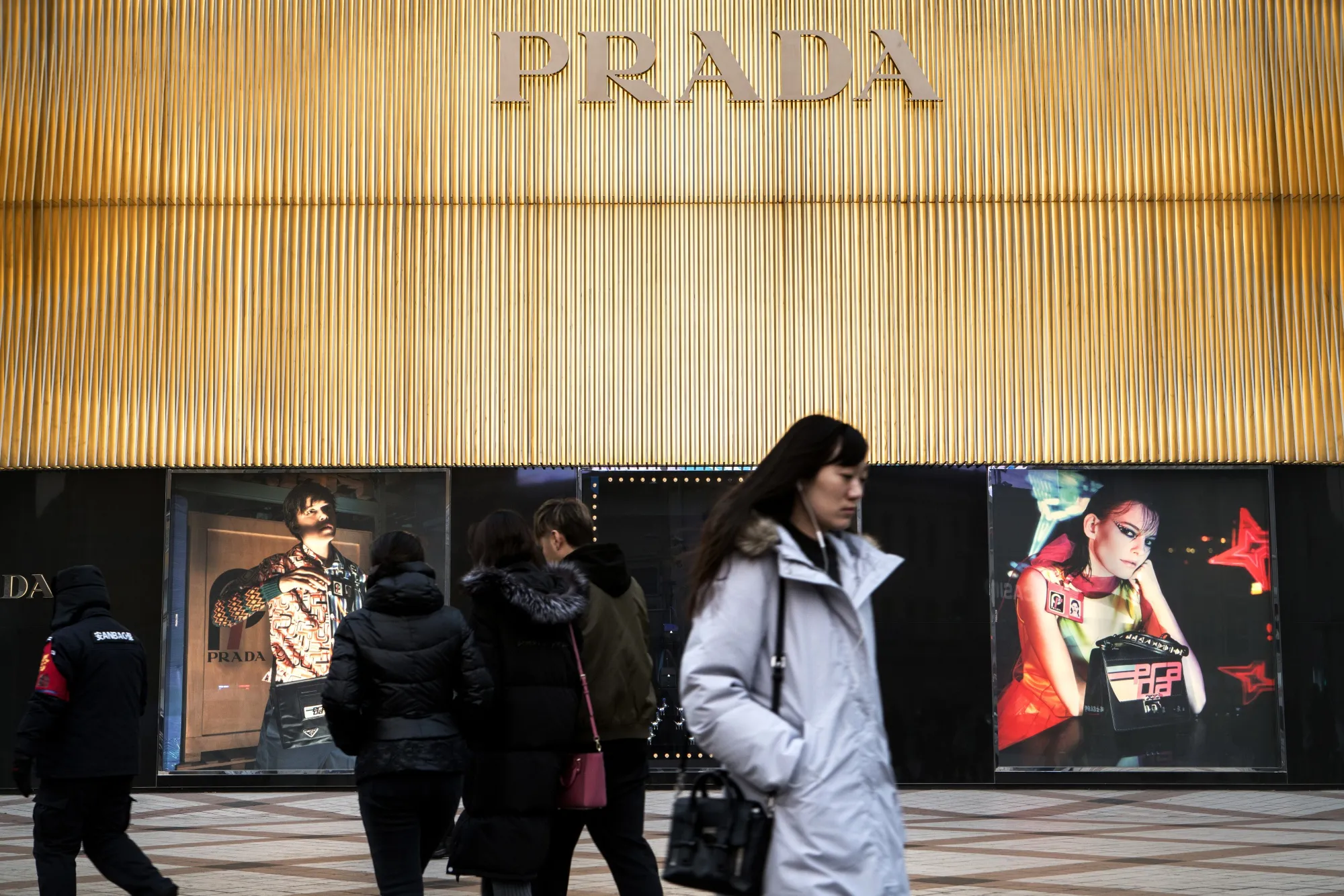Pedestrians walk past a Prada SpA store in&nbsp;Beijing.