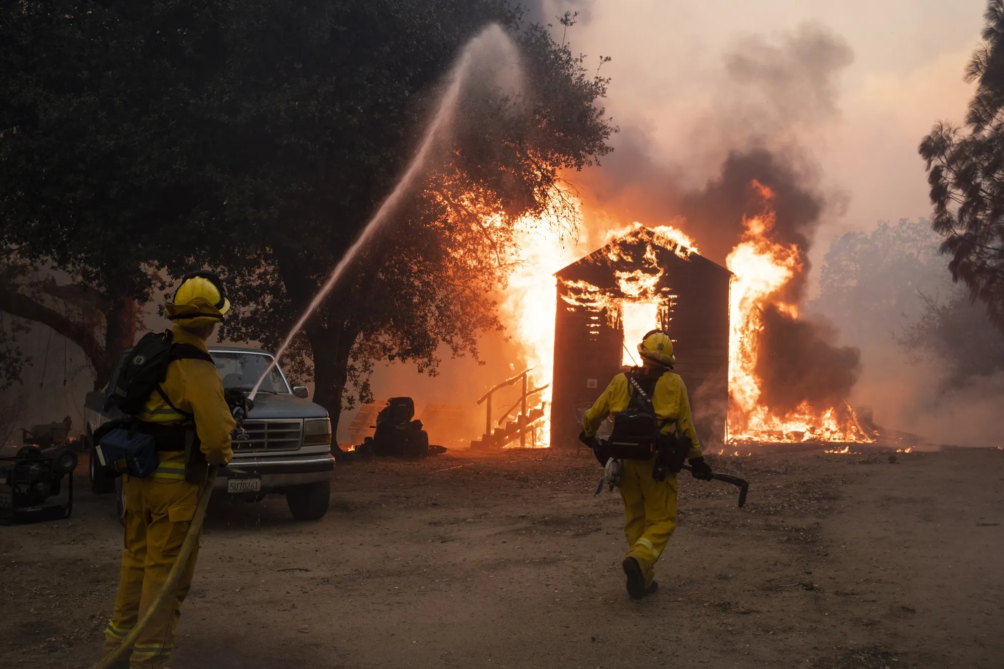 Firefighters work to prevent the fire from spreading during the Zogg fire near the town of Igo in Shasta County, California on Sept. 27, 2020.