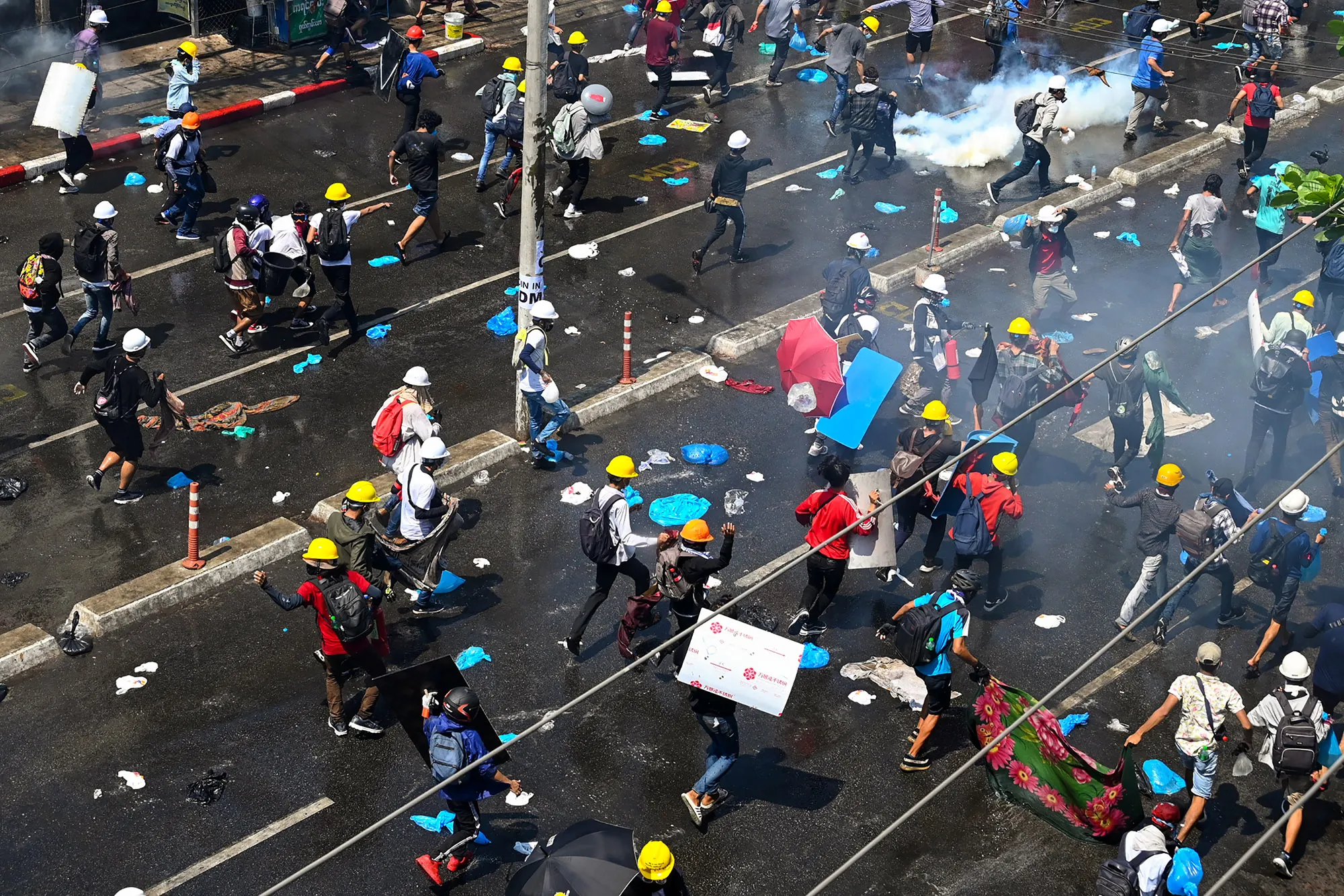 Protesters run after tear gas was fired during a demonstration&nbsp;in Yangon on March&nbsp;1.&nbsp;