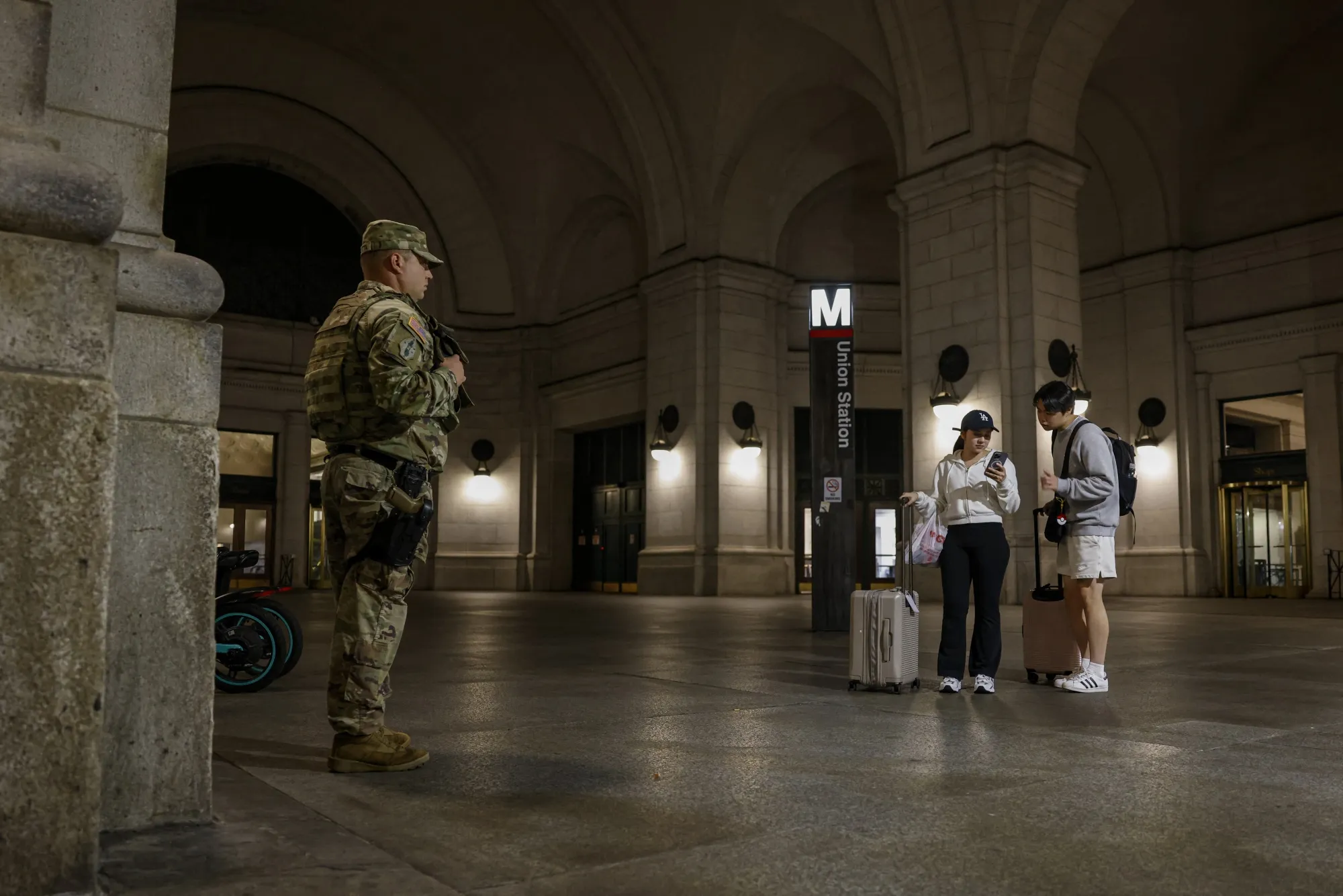 Members of the National Guard carrying sidearms stand outside Union Station in Washington, D.C.