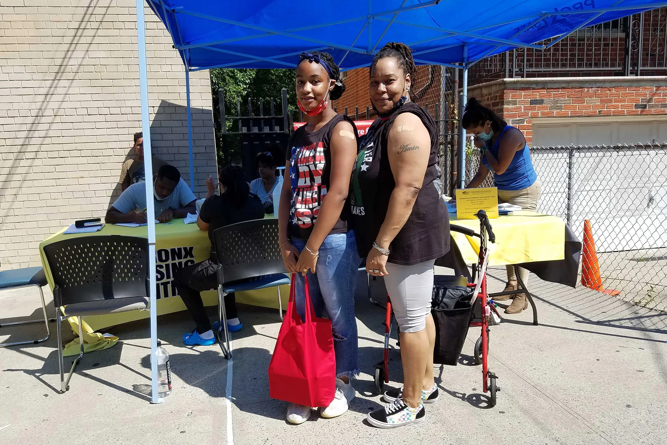 A day after the FDA approved a Covid-19 vaccine, Sharray Gray and her daughter&nbsp;Amina Coleman got vaccinated outside a library in the Bronx at a mobile clinic organized by Bronx Rising Initiative.