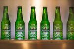 Bottles of Heineken lager beer sit on display in the Heineken NV Experience bar
