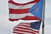 The Puerto Rican and US flags are seen in the Old Town district February 9, 2015 in San Juan, Puerto Rico.
