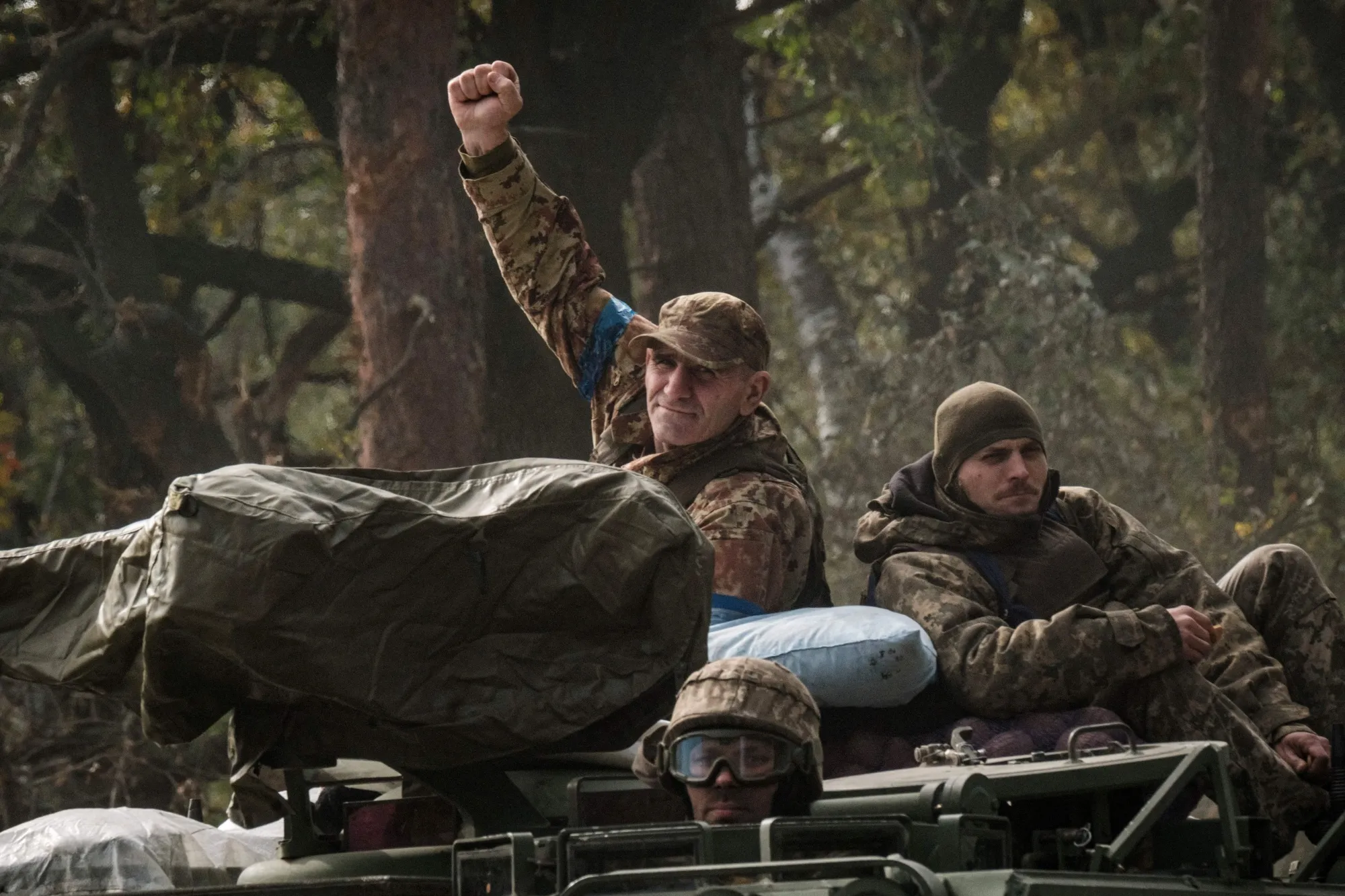 A Ukrainian soldier raises his fist on an armored vehicle near the recently retaken town of Lyman in Donetsk region, Ukraine.