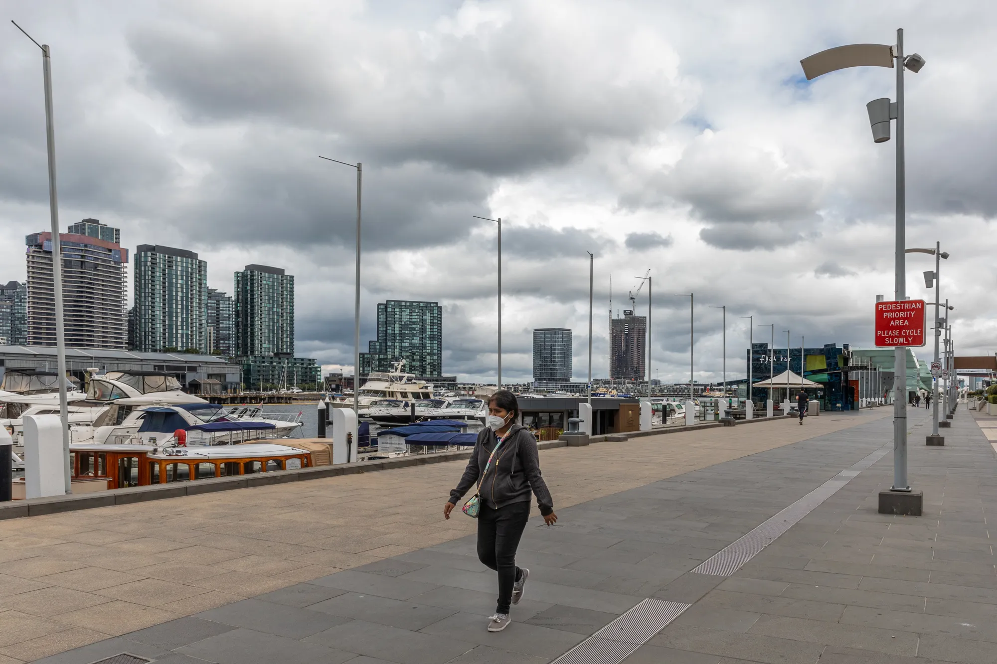 A pedestrian walks through a near-deserted street during lockdown in Melbourne, Australia, on Sept. 25.