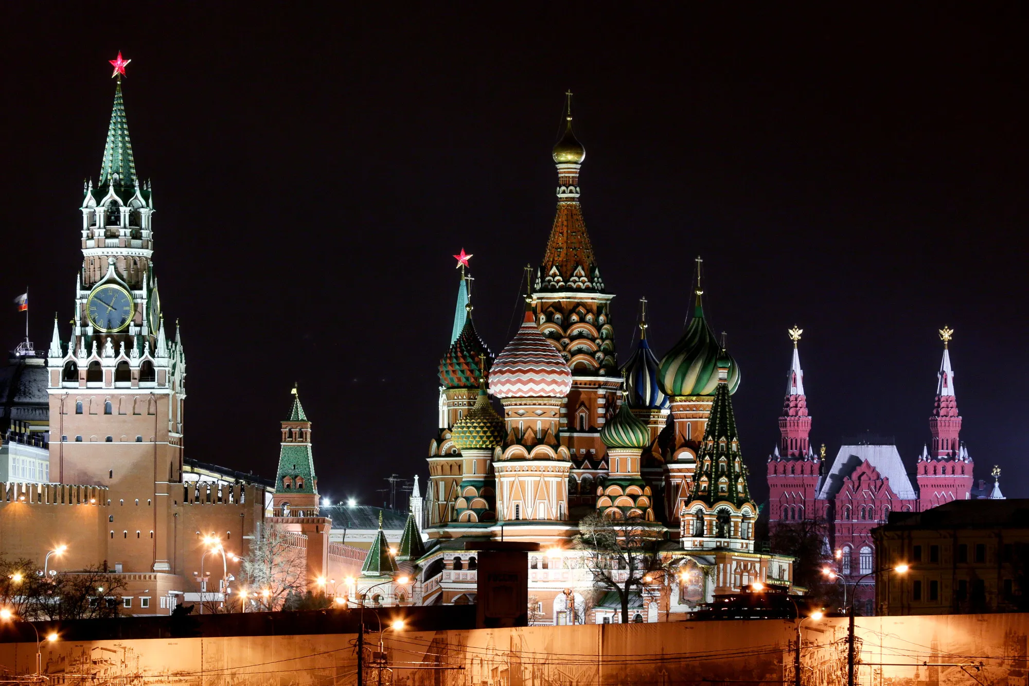 The Kremlin and Spassky tower, left, and St Basil's cathedral, right, stand illuminated at night in Moscow, Russia.