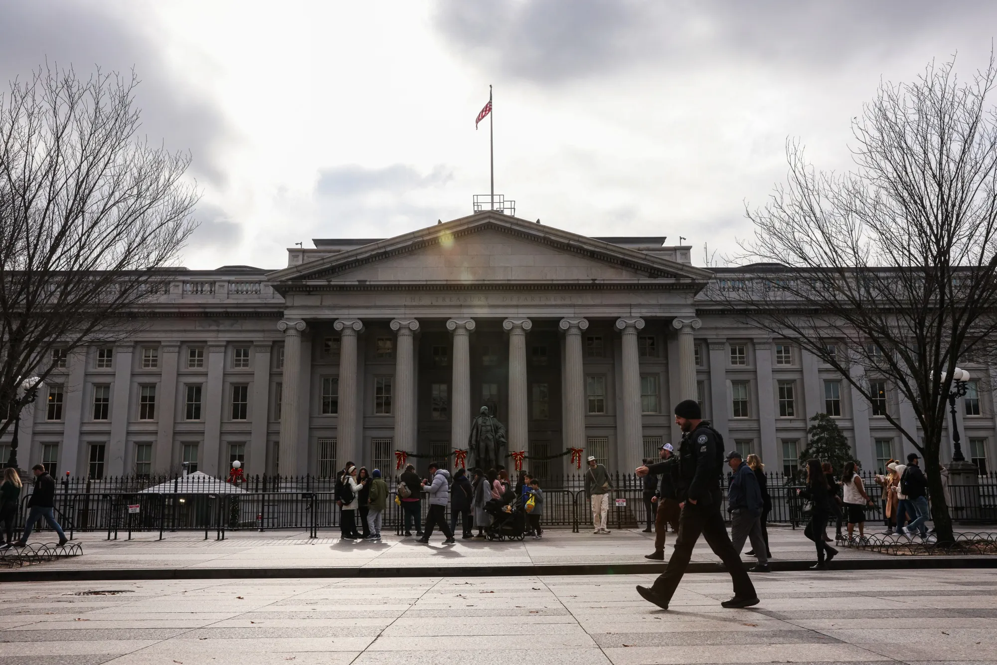 Pedestrians walk past the&nbsp;Treasury Department in Washington.