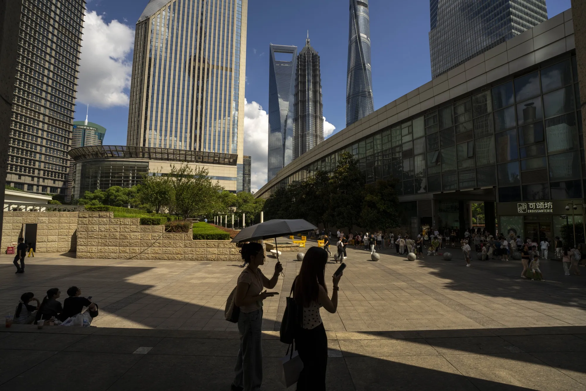 Pedestrians in Pudong's Lujiazui Financial District in Shanghai, China.