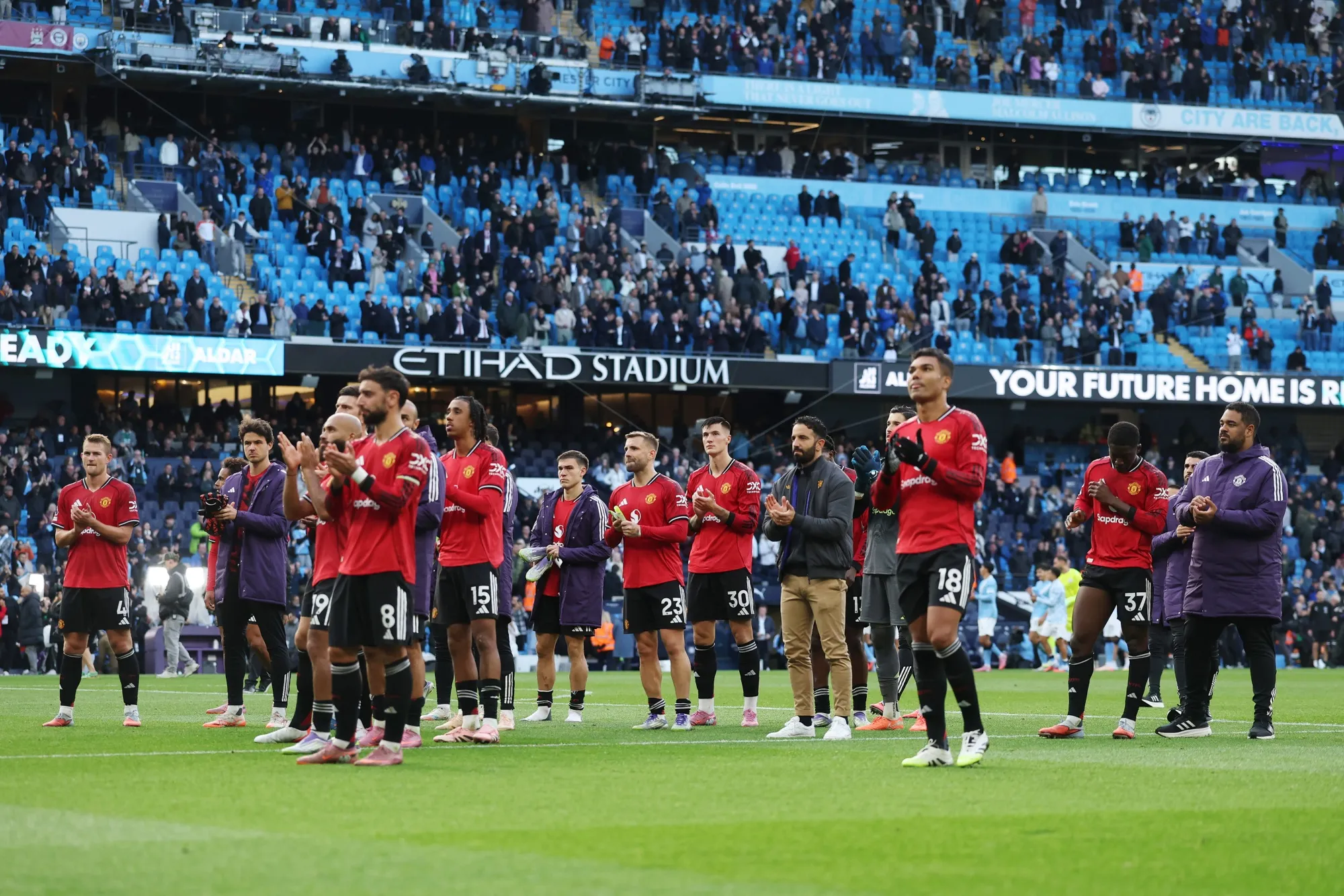 Manchester United players applaud the fans after the team's defeat by Manchester City in Manchester, on Sept. 14.