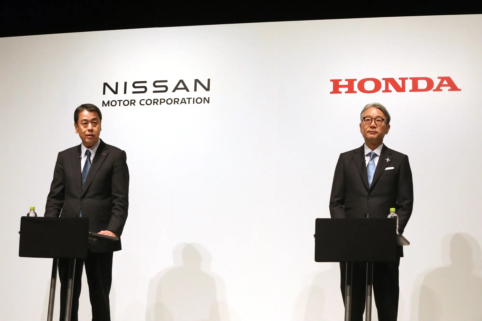 Nissan's CEO Uchida, left, and Honda's CEO Mibe during a news conference on March 15.