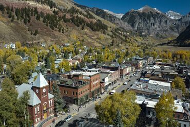 aerial view of Main Street old western ski town of Telluride in autumn color surrounded by mountains
