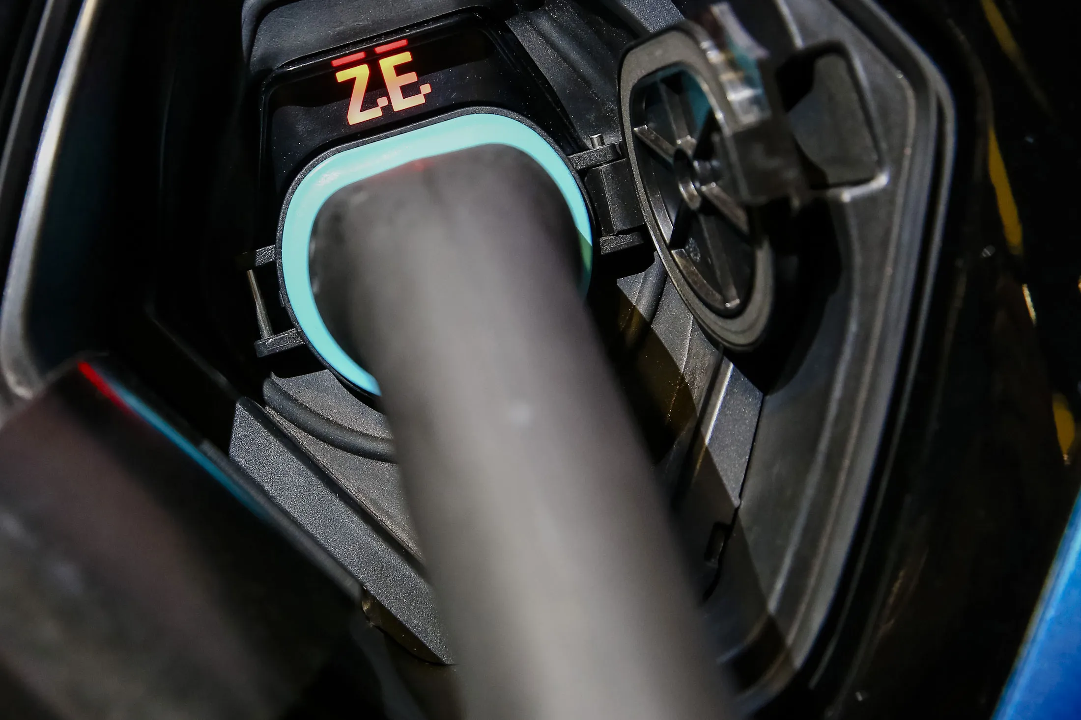 An electrical charging cable sits connected to a demonstration model of a new battery-powered Zoe city car.
