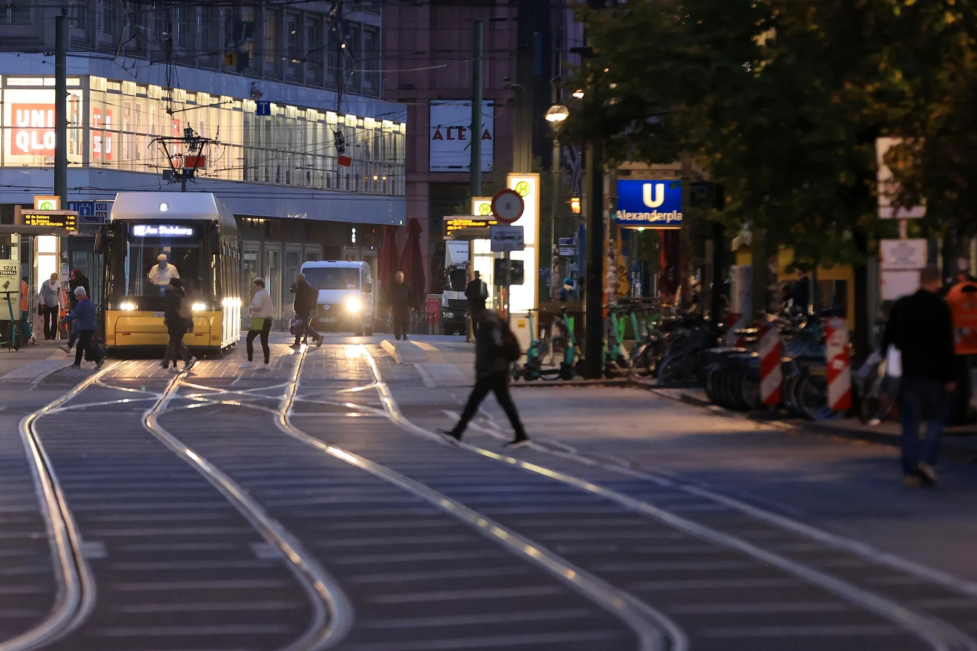 Commuters cross tram lines at Alexanderplatz in central Berlin, Germany.