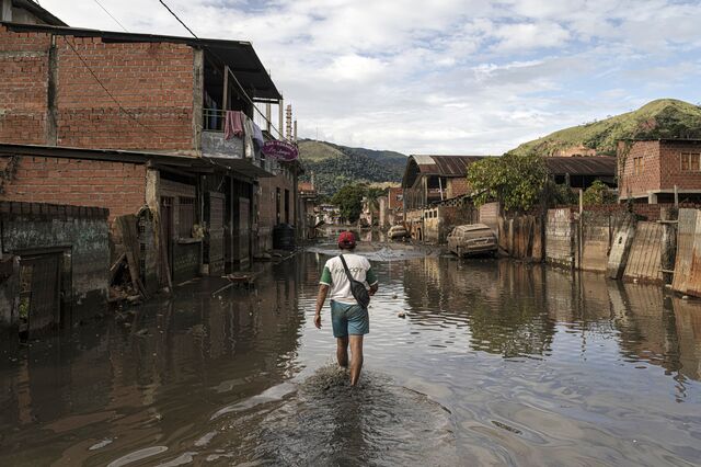 A resident wades through flooded streets in the mining town of Tipuani.