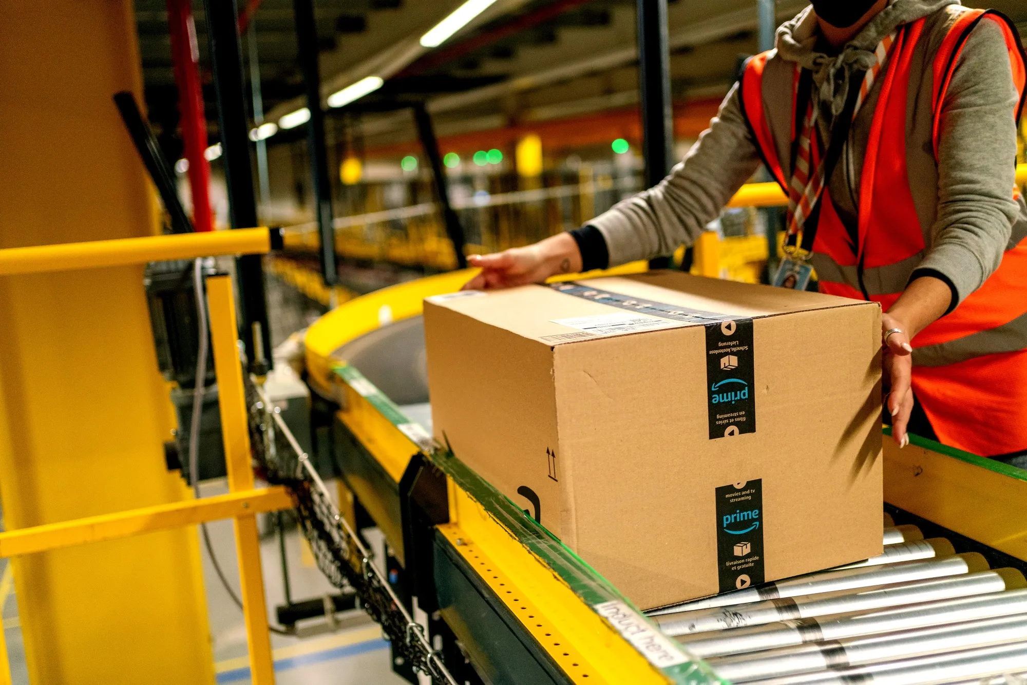 A worker collects an Amazon Prime package at an Amazon.com Inc. fulfillment center.