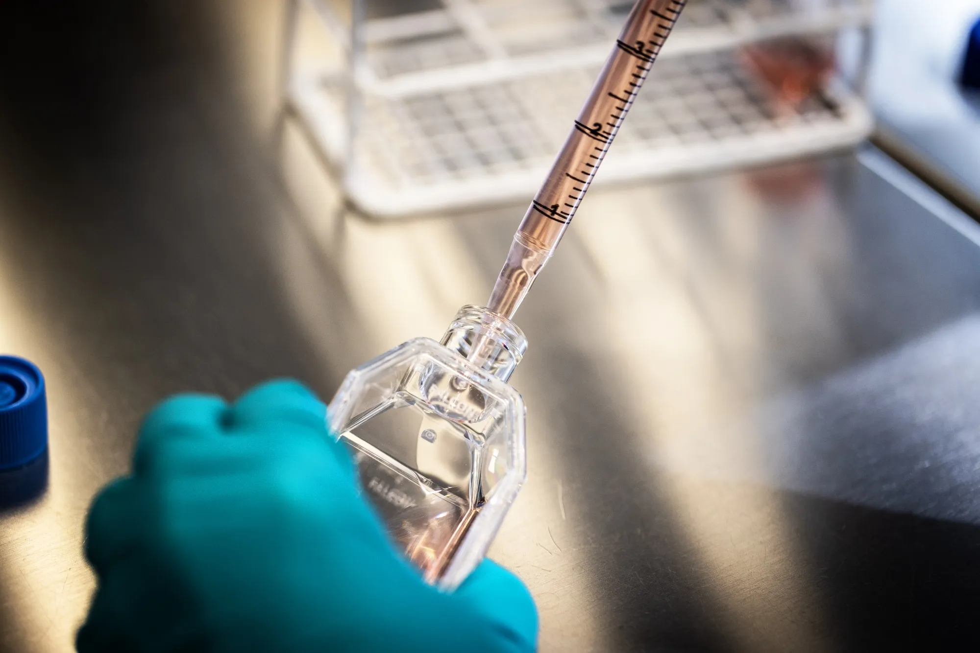 A scientist uses a culture flask and pipette in the cell therapy labs at the Novo Nordisk A/S research facilities in Malov, Denmark.