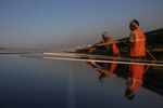 Workers wash photovoltaic panels at a solar farm in Pavagada, Karnataka, India, on Thursday, Feb. 24, 2022. India plans to expand its solar capacity to 280 gigawatts by the end of this decade from about 51 gigawatts now, but its manufacturing capacity can only currently meet around half of that requirement.