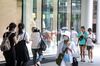 People walk past a shopping mall in Taipei, Taiwan, on Thursday, July 30, 2020. 