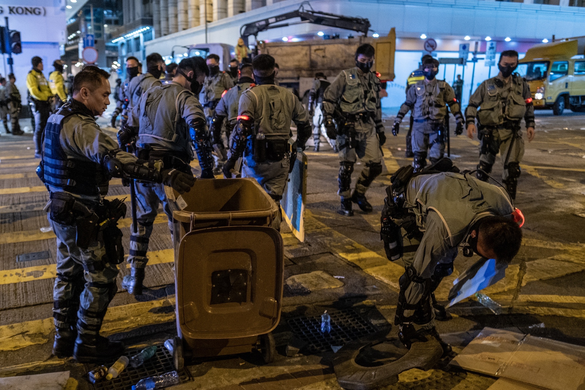 Riot police remove a barricade set by demonstrators in Central, Dec. 8.