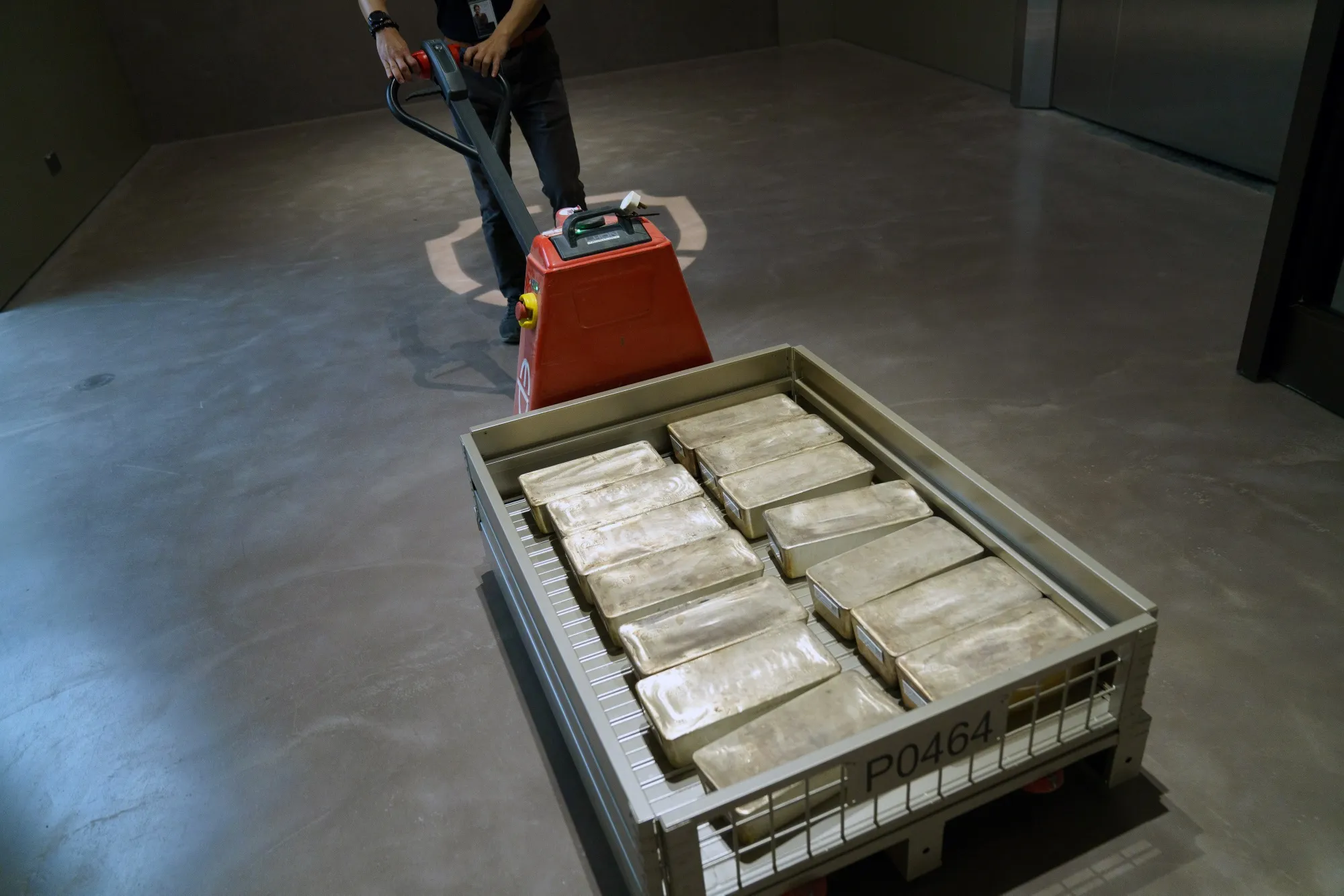 An employee transports silver bars.