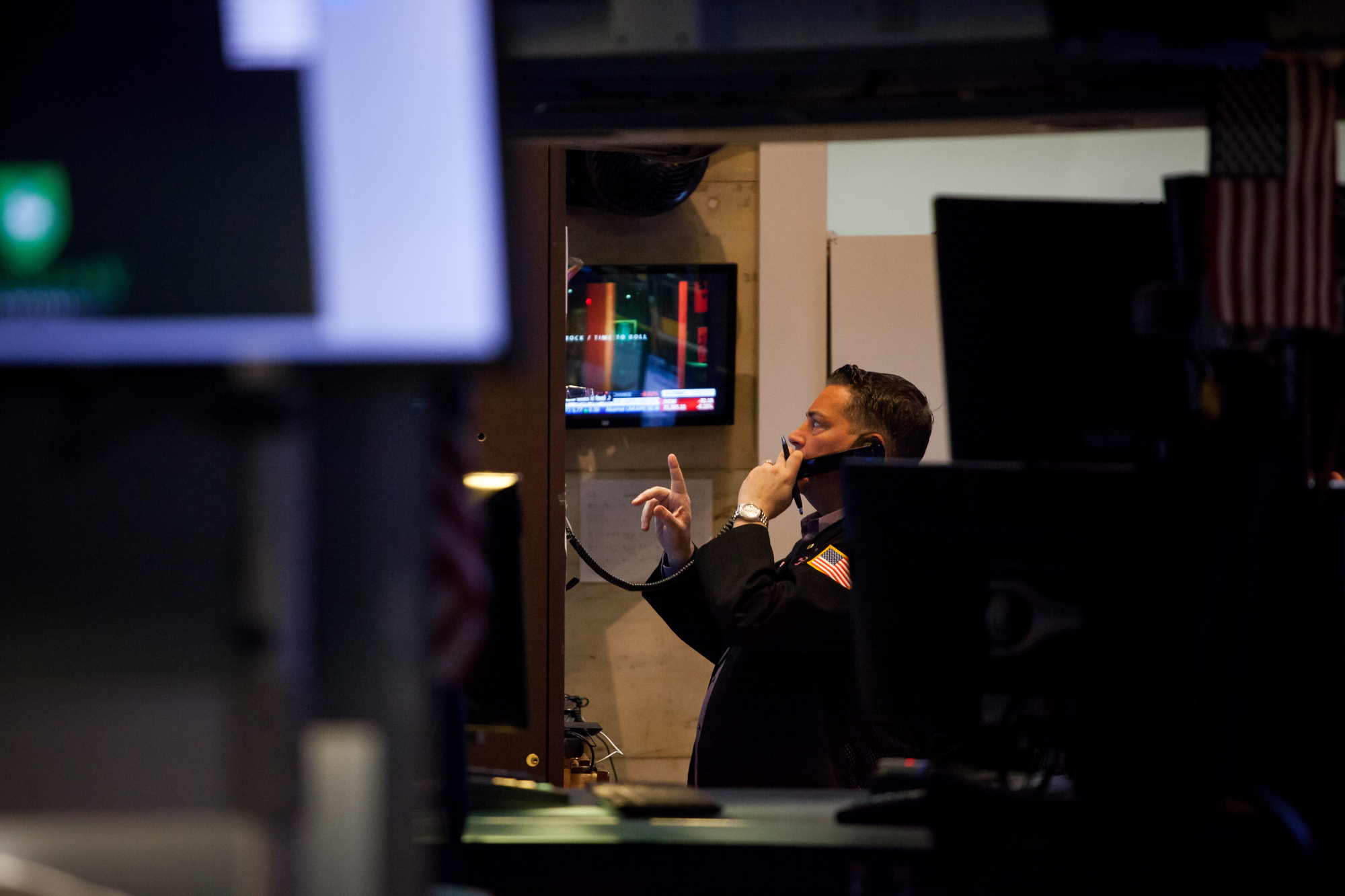 A trader talks on the phone while working on the floor of the New York Stock Exchange.