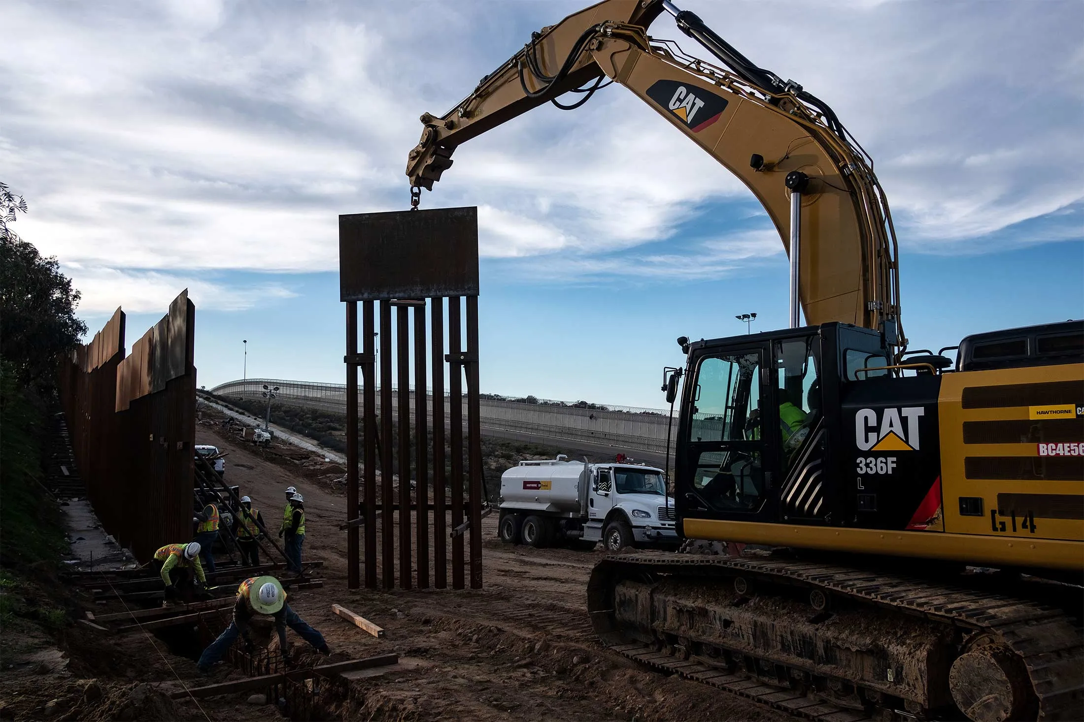 A construction crew works on replacing the U.S.-Mexico border fence as seen from Tijuana, in Baja California state, Mexico, on Jan. 9.&nbsp;