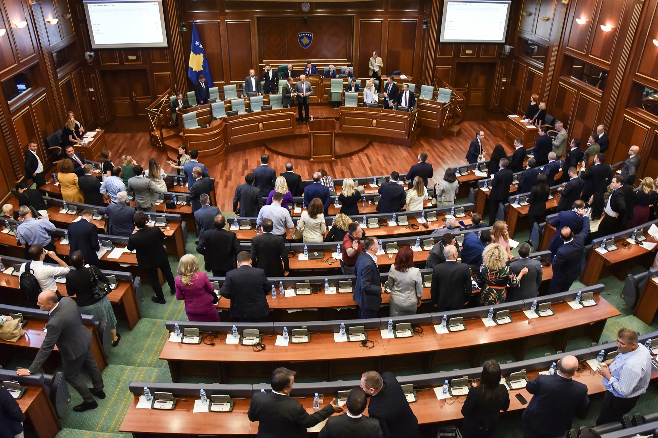 Members of the Kosovo Parliament leave after a session on Aug. 22.