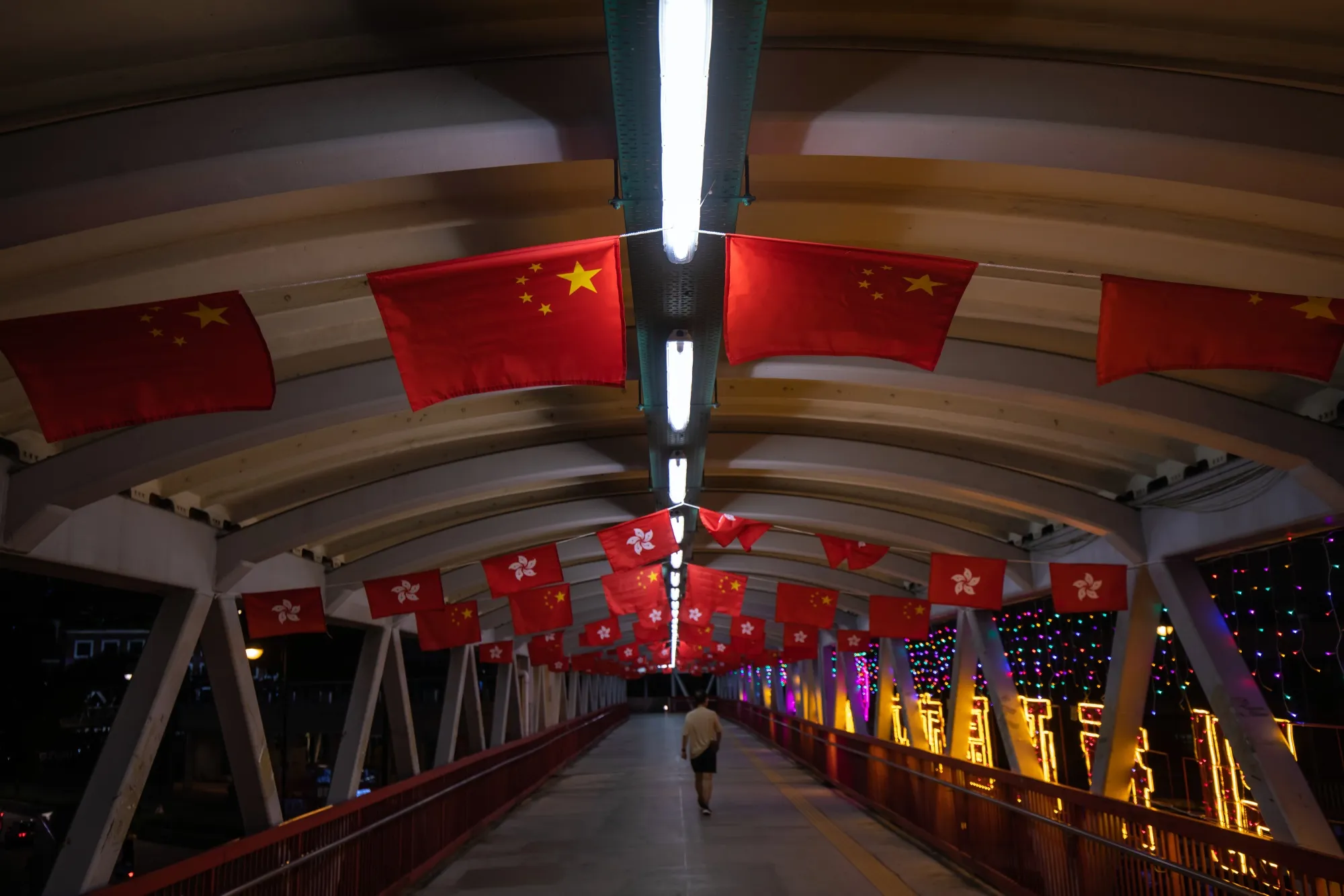 The flags of China and Hong Kong Special Administrative Region&nbsp;hang along a pedestrian footbridge in Hong Kong on June 22.