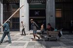 Pedestrians pass the Brasil Bolsa Balcao (B3) stock exchange in Sao Paulo, Brazil.
