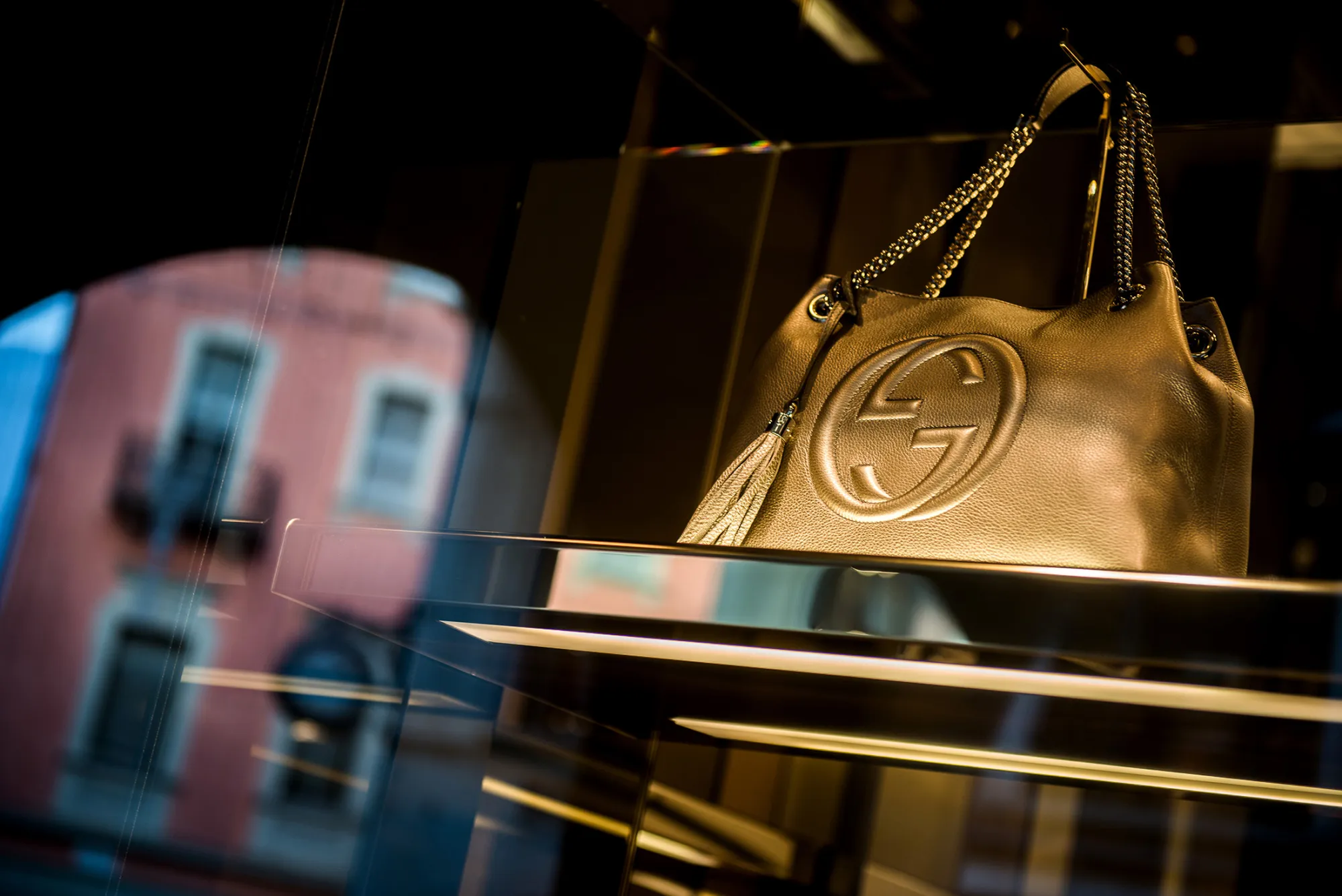 A gold leather handbag sits in the window display of a Gucci luxury goods store, operated by Kering SA, in Lugano.
