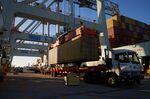Shipping containers are loaded onto trucks at the Port of Boston in Massachusetts.&nbsp;