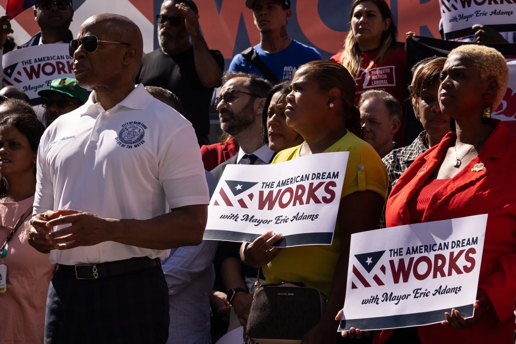 New York Mayor Eric Adams (left) attends a rally calling for expedited federal work authorization for asylum seekers on Aug. 31. 