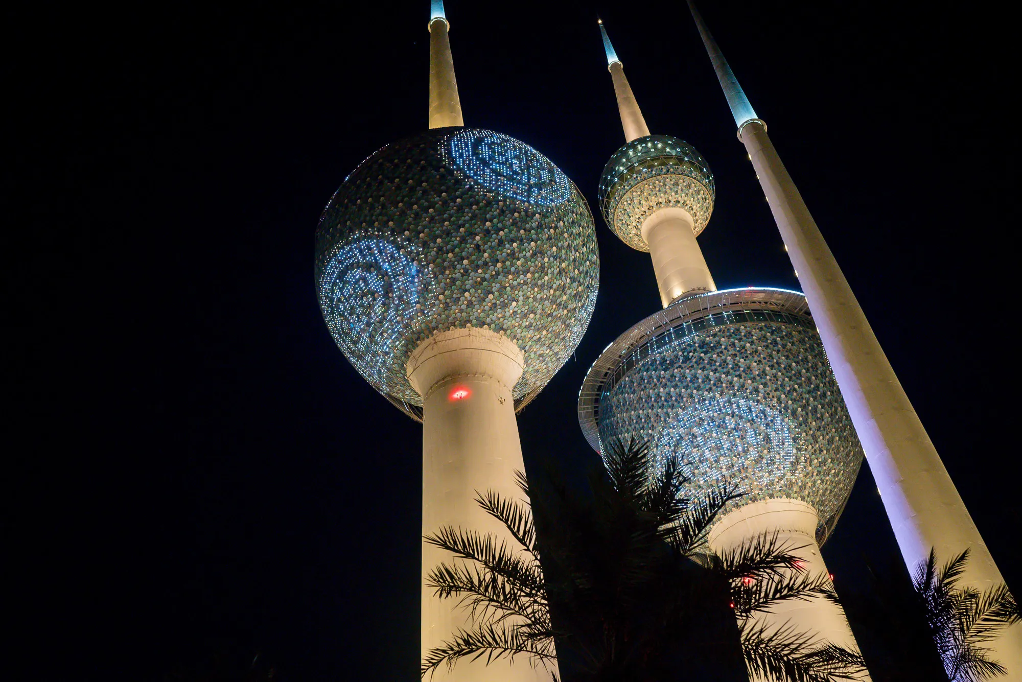 Lights illuminate the Kuwait Towers in Kuwait City.