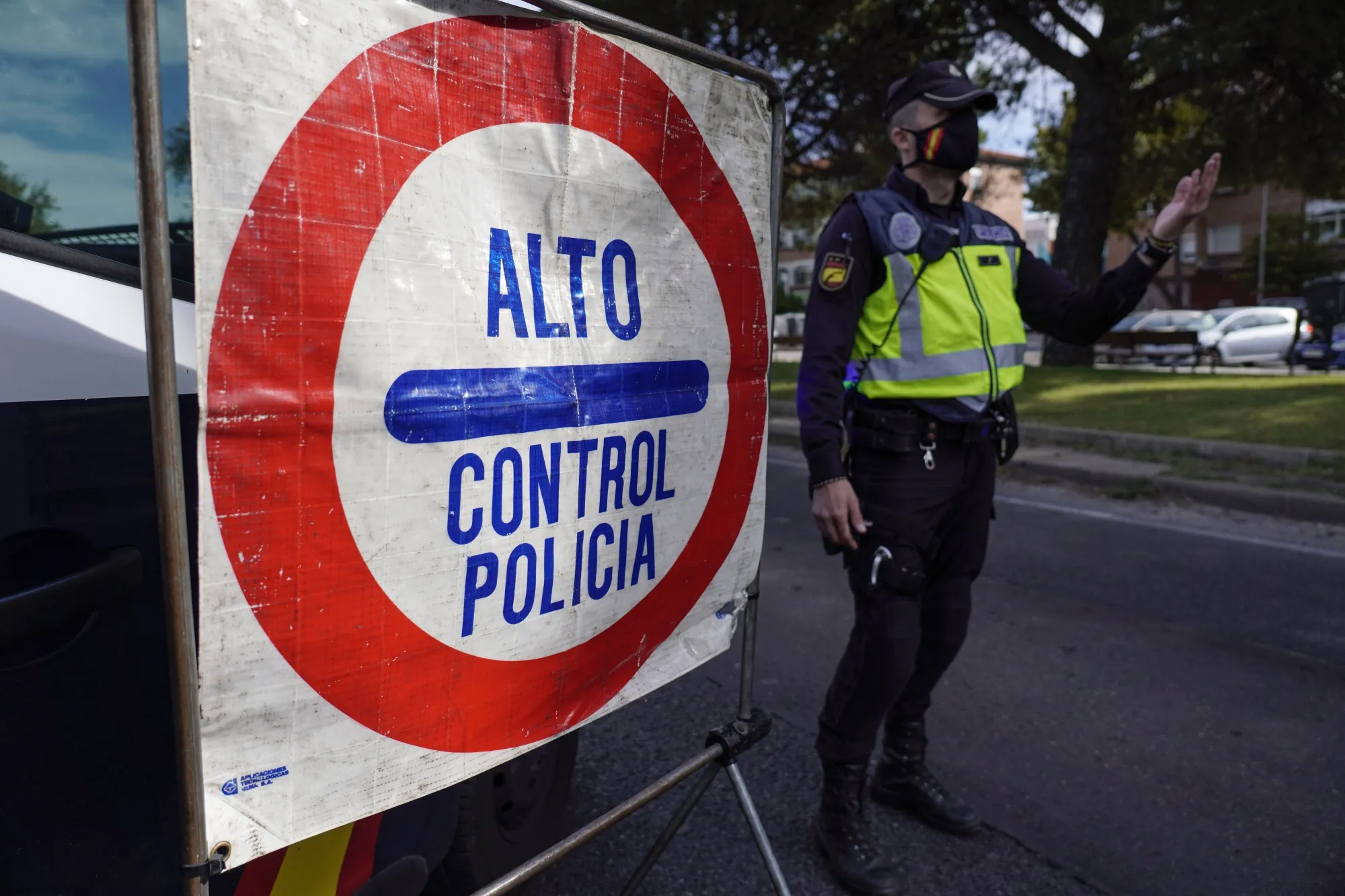 A police officer mans a roadside checkpoint in Madrid, Spain, Oct. 8.