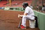 Play ball: Bat boy Chris Cundiff of the Boston Red Sox wears a mask during the third inning of a game against the Baltimore Orioles on July 25&nbsp;at Fenway Park in Boston, Massachusetts.&nbsp;