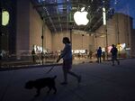 Pedestrians pass in front of the Apple Inc. store on Manhattan's Upper West Side in New York.
