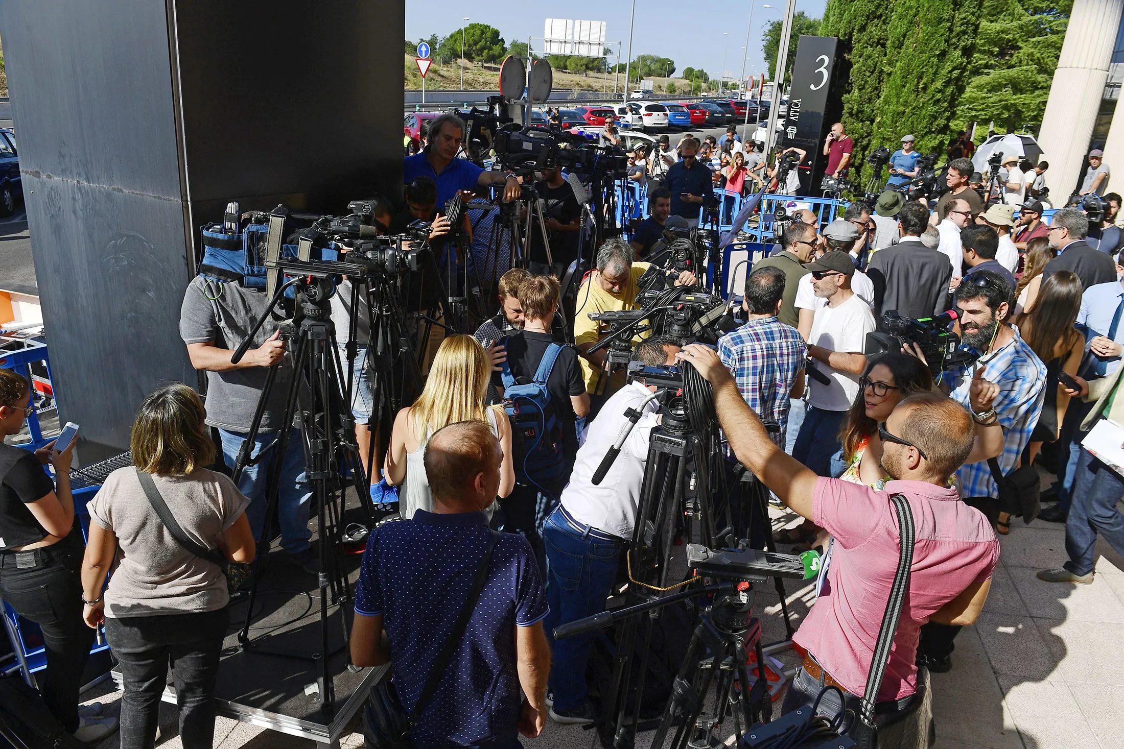 Police and media stand waiting for the arrival of Real Madrid's Portuguese forward Cristiano Ronaldo to appear at a court in Madrid on July 31.
