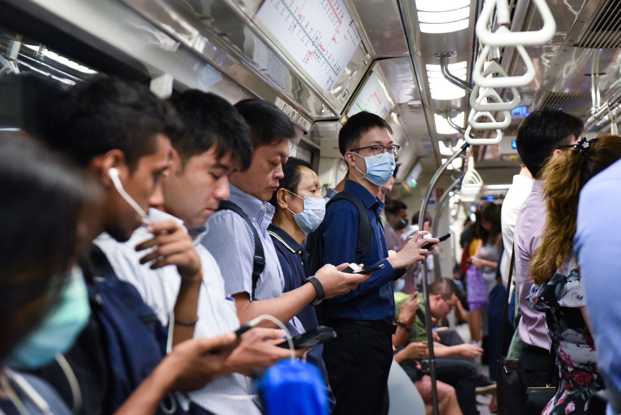Commuters wear face masks on the Mass Rapid Transit train as a preventive measure against the COVID-19 coronavirus in Singapore.