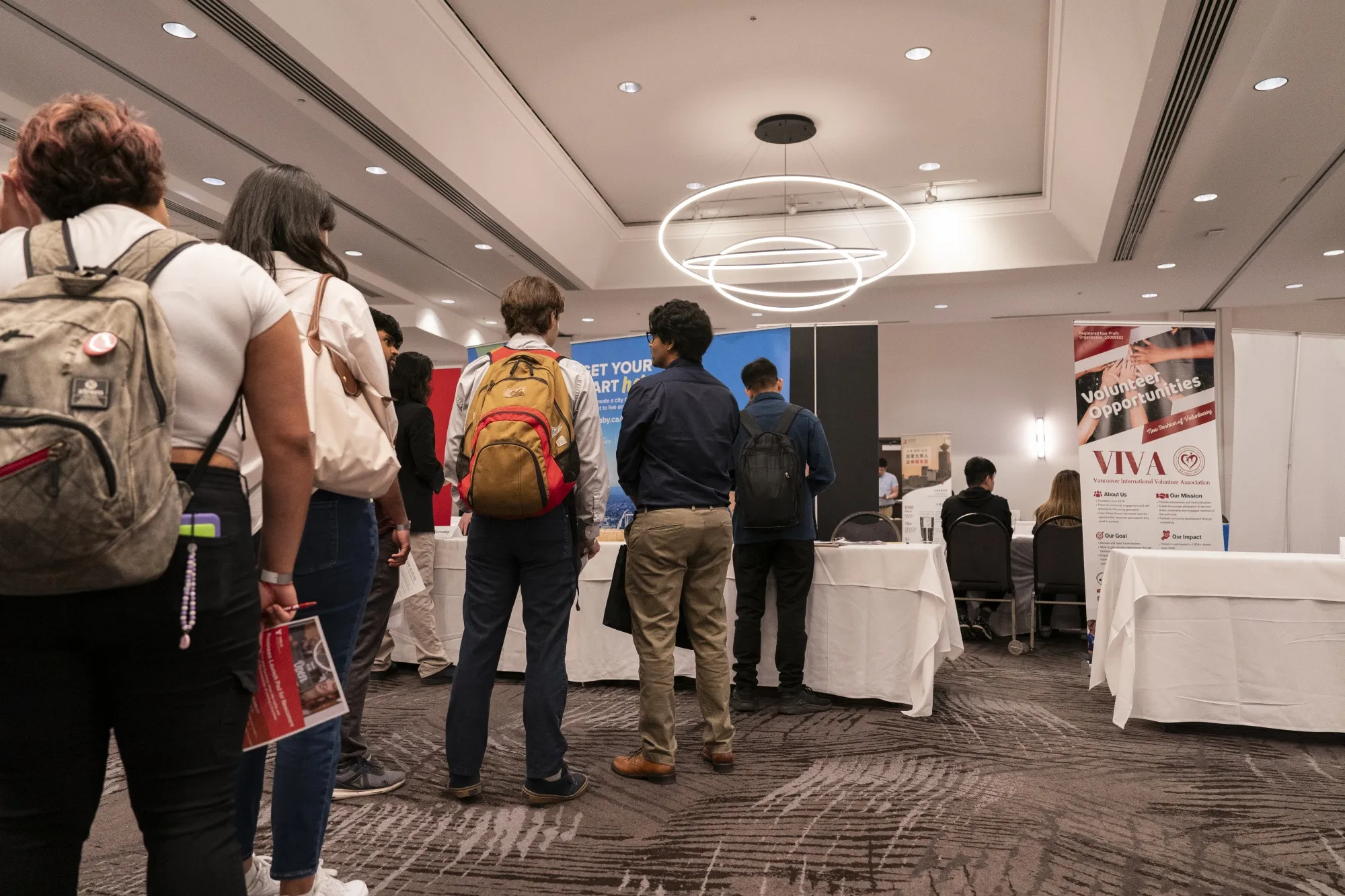 Attendees wait in line at a career fair in Burnaby, British Columbia.