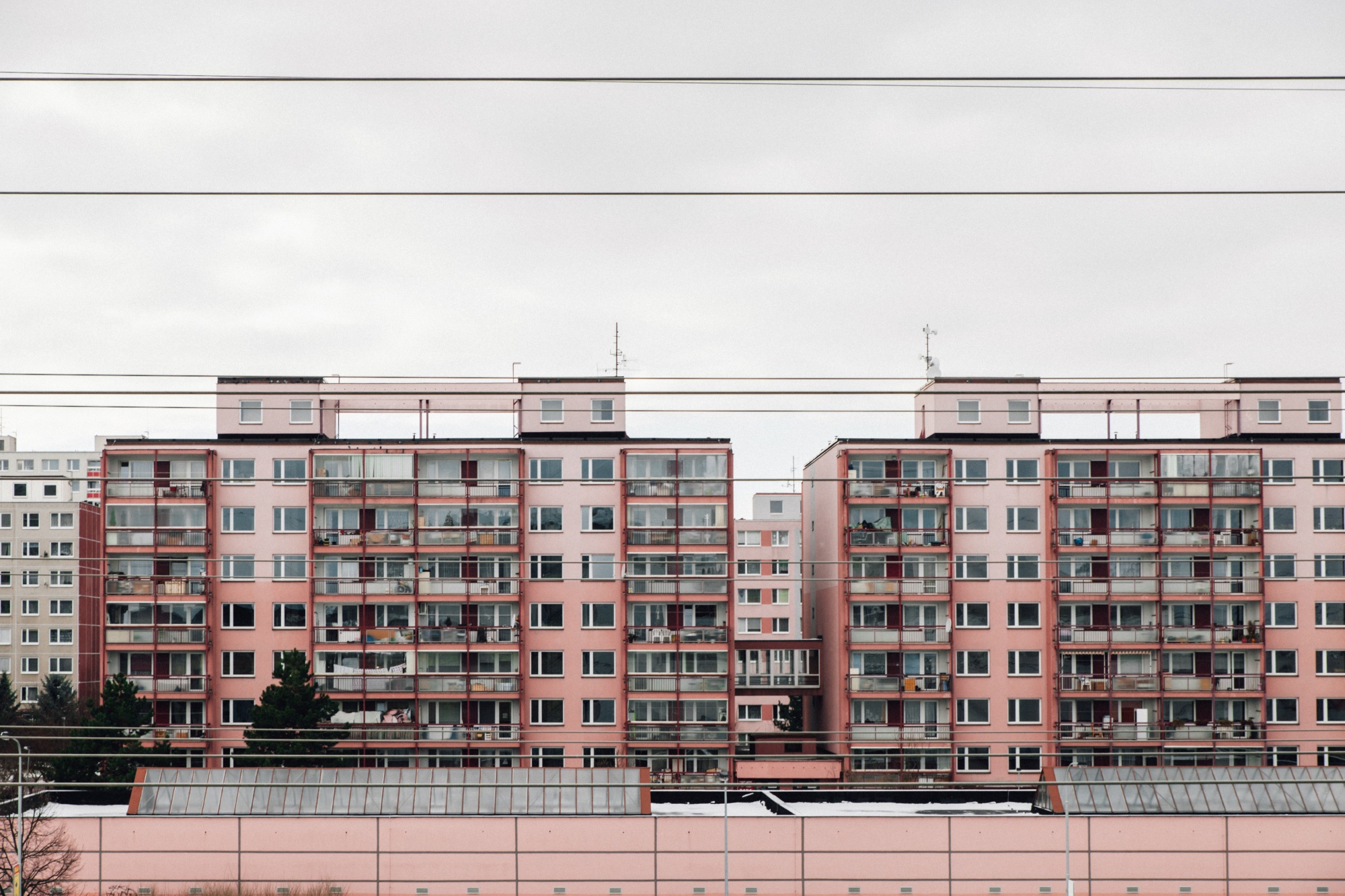 The fading coral color scheme and revamped balconies on these&nbsp;Prague paneláks are typical of recent renovations.