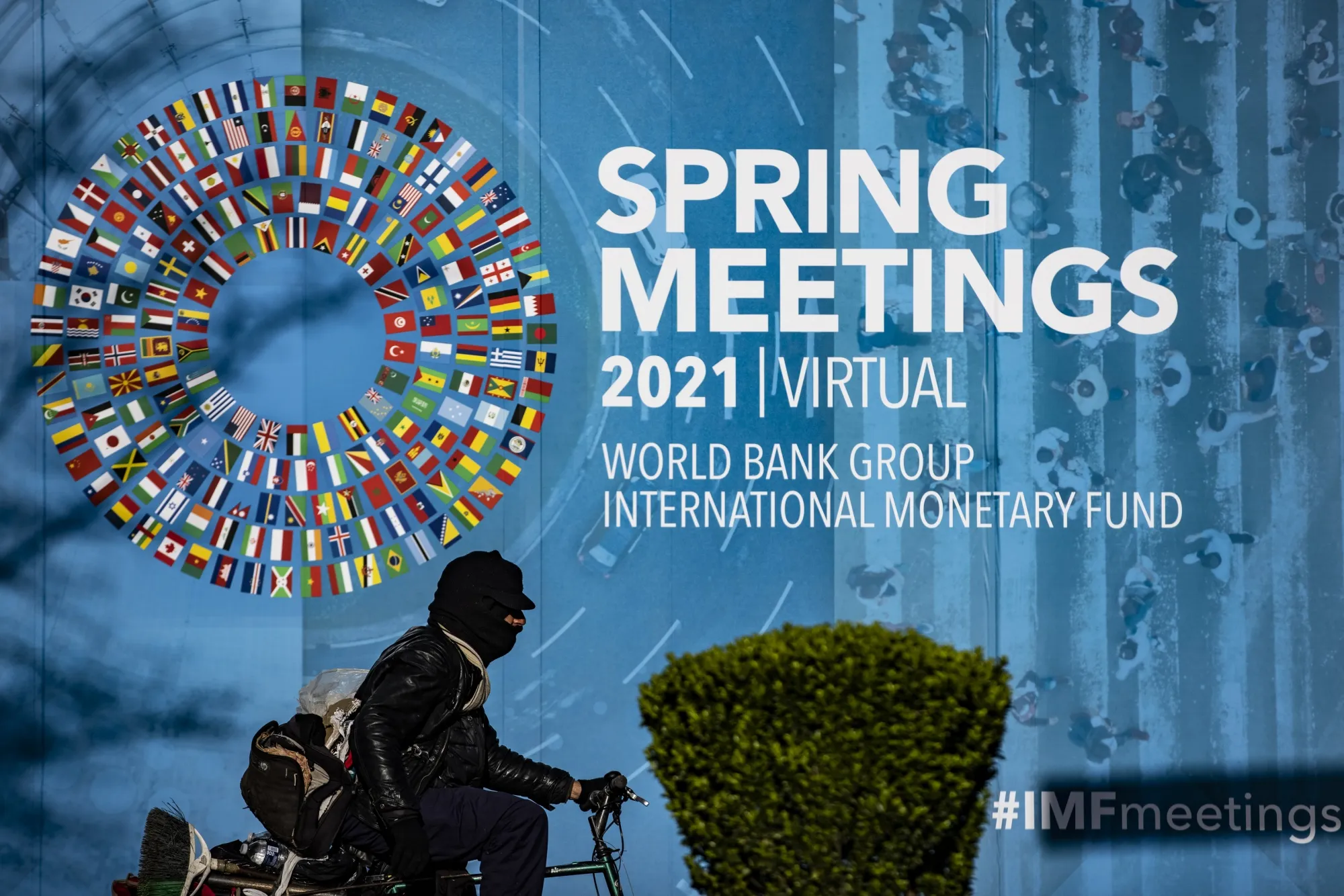 A cyclist rides past the International Monetary Fund’s headquarters at sunrise in Washington on April 3.