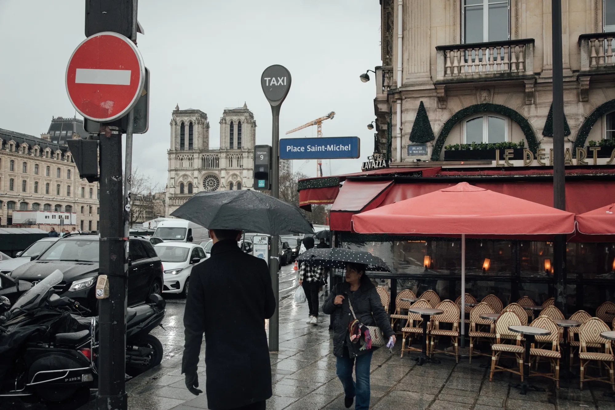 Pedestrians pass an empty restaurant terrace in Paris.