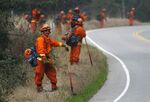 Inmates holding a fire line during a burn out operation in Big Sur, California, December 2013.