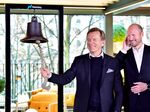 Hakan Samuelsson, left, and Bjorn Annwall perform a bell-ringing ceremony at the Volvo showroom in Stockholm, on Oct. 28.