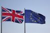 The U.K. national flag, left, flies beside an European Union (EU) flag outside the Chancellery in Berlin, Germany, on Tuesday, April 9, 2019. U.K. Prime Minister Theresa May is visiting Berlin and Paris today as part of her efforts to win a short delay to Britain’s departure from the European Union, while at home some in her Conservative Party try to throw her overboard.