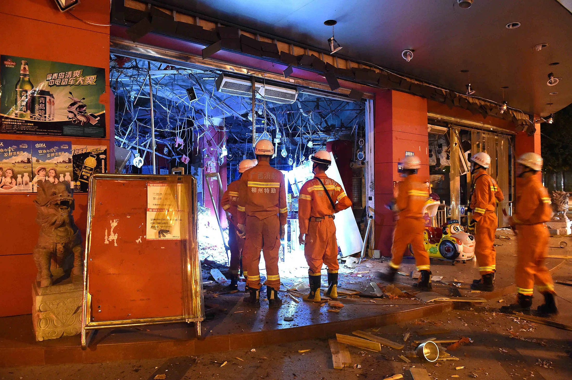 Firefighters enter a blast site after suspected letter bombs exploded in China's Guangxi Zhuang Autonomous Region.
