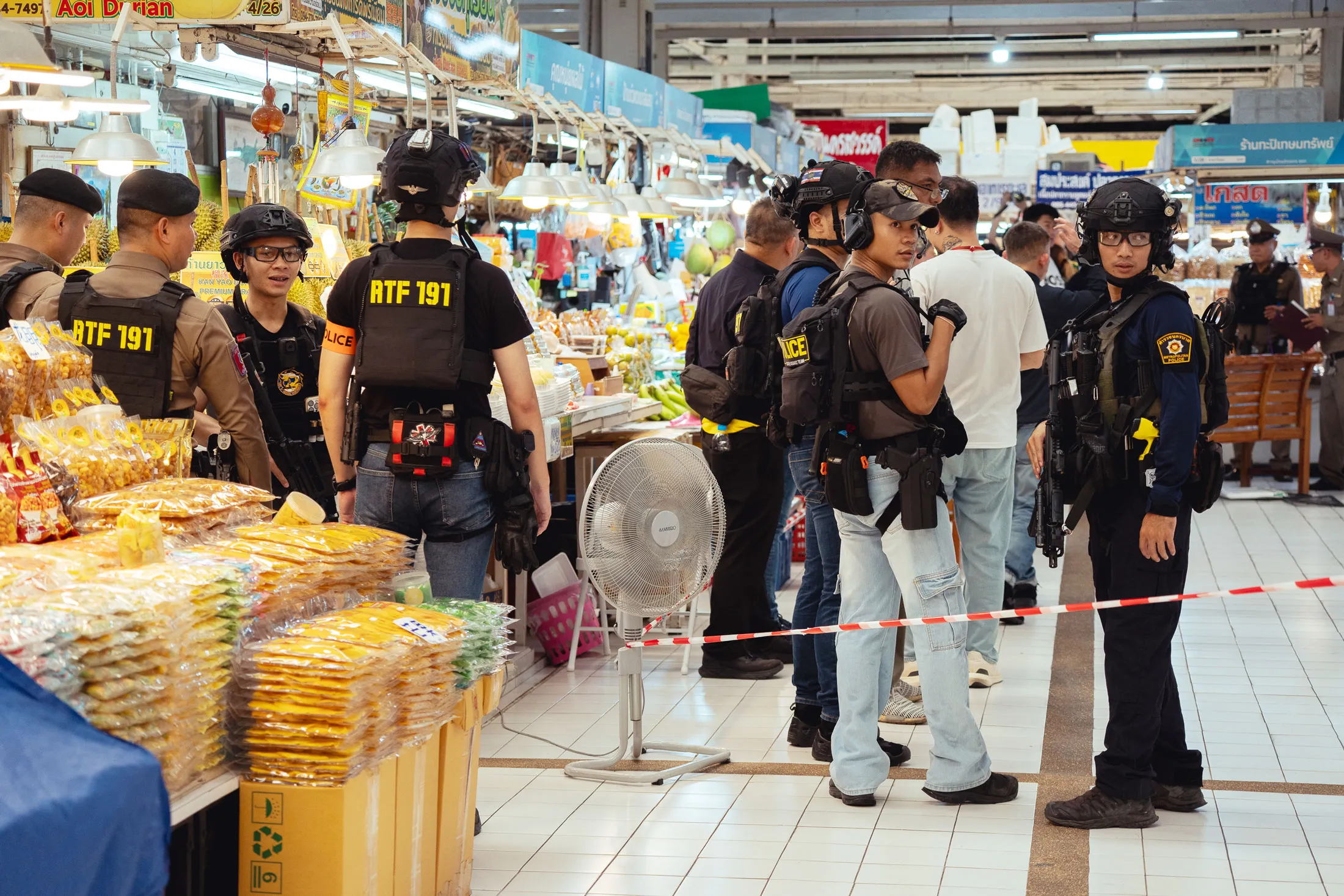 Police attend the scene at Or Tor Kor market in Bangkok, on July 28.