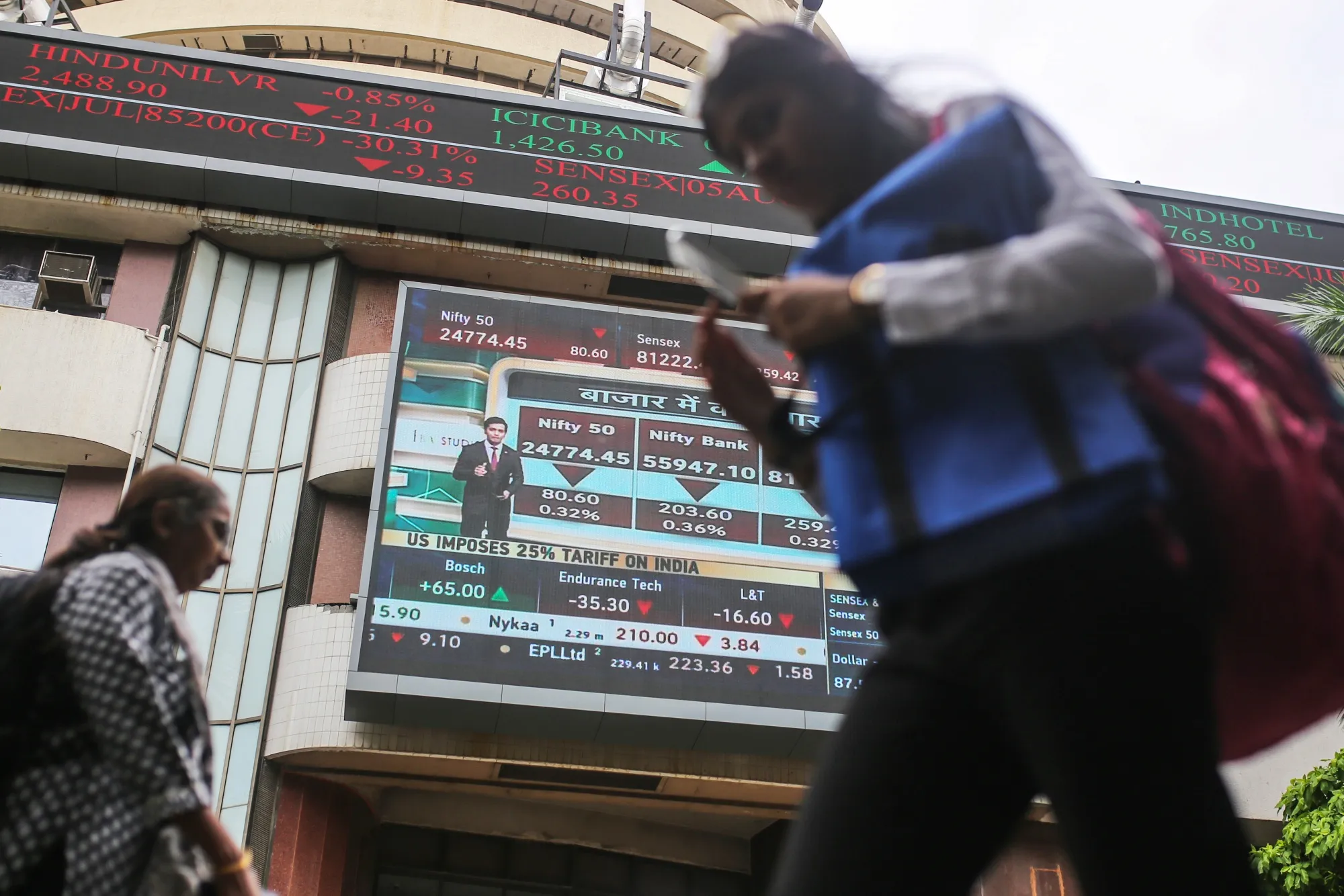 A screen display stock prices at the Bombay Stock Exchange (BSE) building in Mumbai.